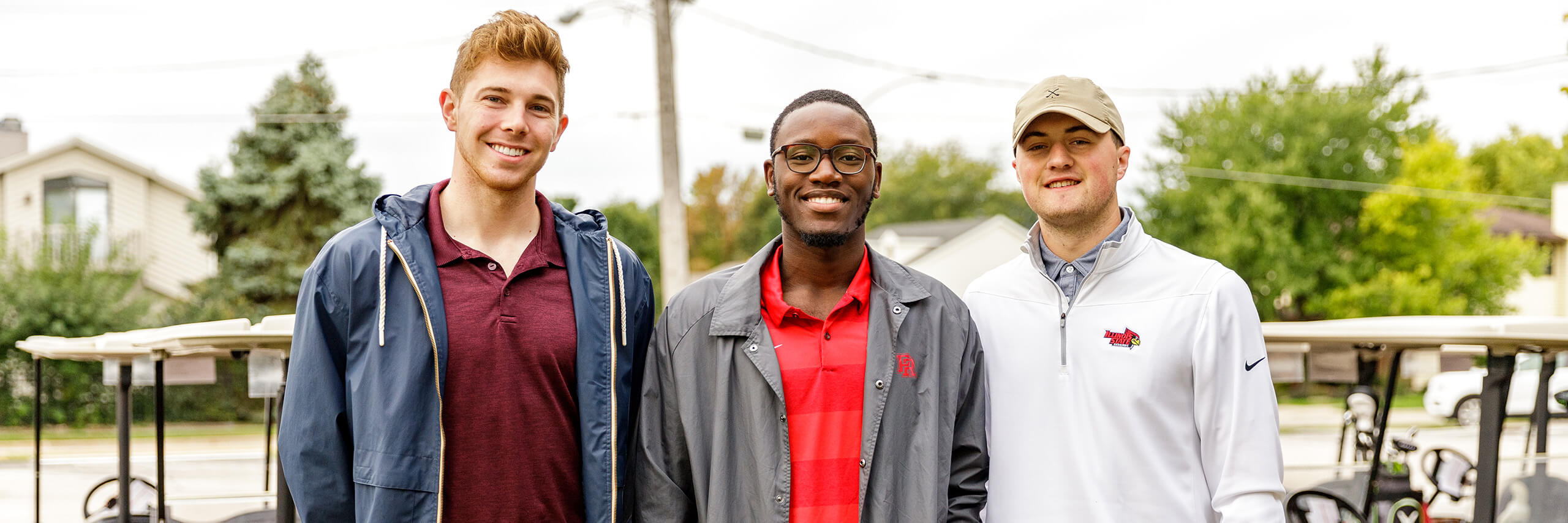 Three alumni standing together.