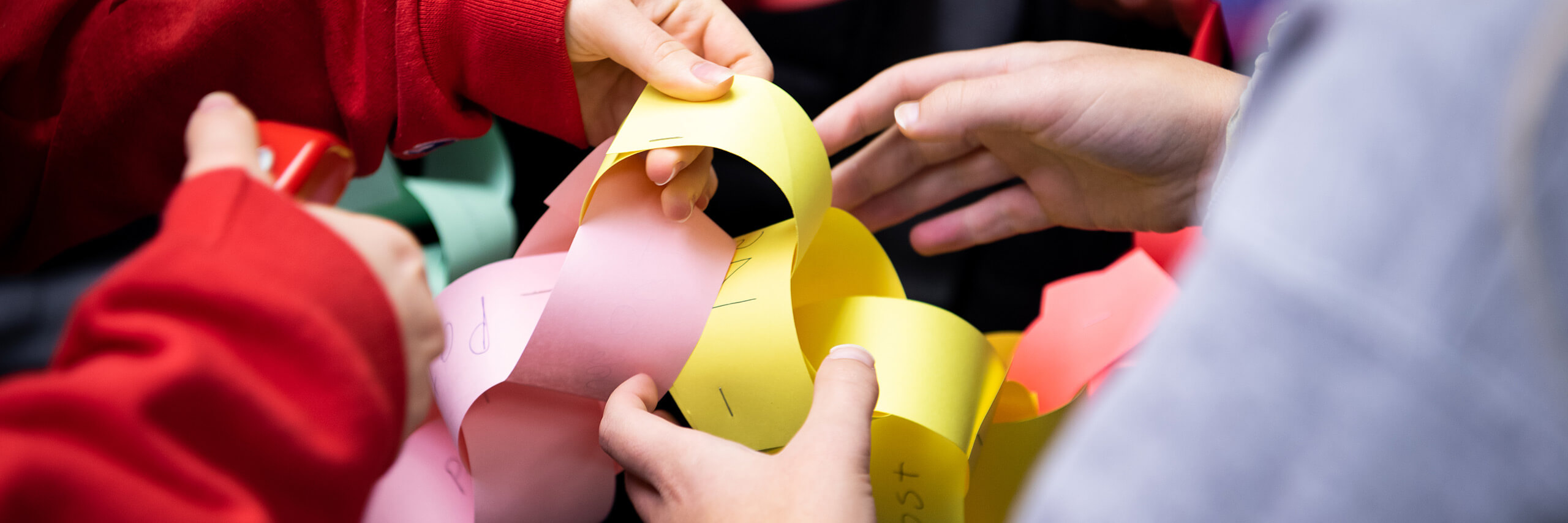 Group creating a colorful paper chain.